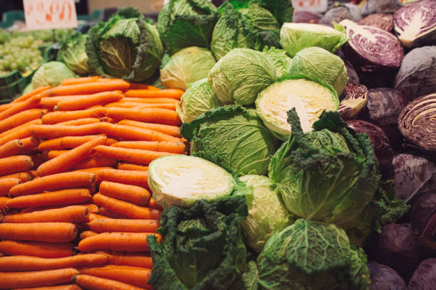 In the market hall, Budapest , November 14 2018..'Budapest, Hungary - People are looking and selling in a market hall, in Budapest, Hungary. Typical winter vegetables, different sorts of cabbage are offered: savoy cabbage, red cabbage and white cabbage. The central market hall is the largest indoor market in Budapest. The hall was built about 1900.
