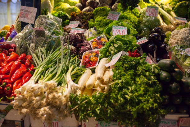 Many kinds of vegetables on the local produce fruit and veg market. Includes runner beans, courgette, lemon, pepper, tomato, chilli, onion, carrot, lemon,  aubergine and many more.