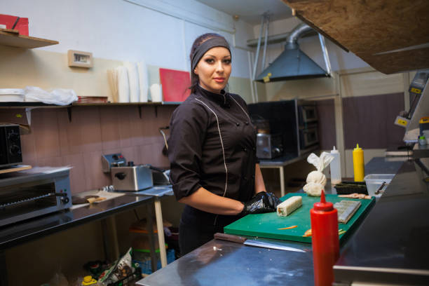 istock beautiful woman chef prepares sushi on restaurant kitchen 1072169040
