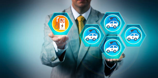 Man Shows Imbalance Between EVs And Charge Ports Male automotive executive highlighting the imbalance between the growing number of electric vehicles and the respective charging infrastructure. Industry concept for challenges of EV fleetification. unbalance stock pictures, royalty-free photos & images