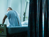 Senior man sitting on hospital bed