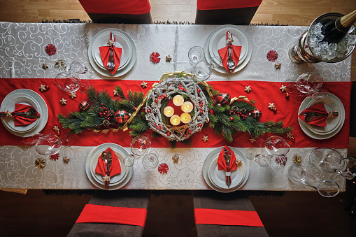 Decorated Table for Christmas Dinner with Candles and Christmas Ornaments