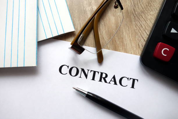 istock Contract document with pen, calculator and glasses on desk 1072177498
