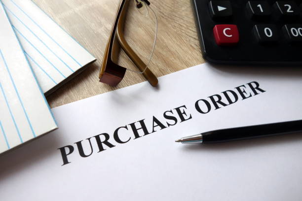 istock Purchase order document with pen, calculator and glasses on desk 1072177760