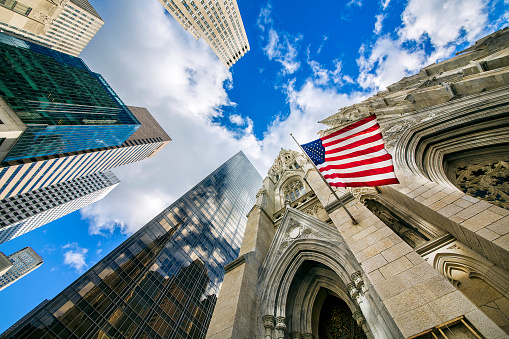 Flag of the United States on St Patrick's Cathedral among Midtown skyscrapers, Manhattan, New York