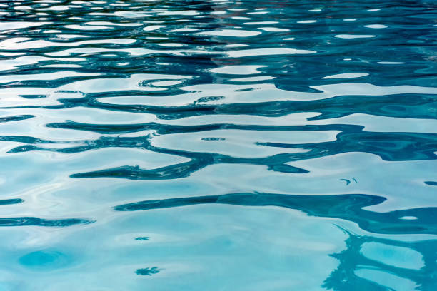 текстура и рябь поверхности воды - flowing blue rippled environment стоковые фото и изображения