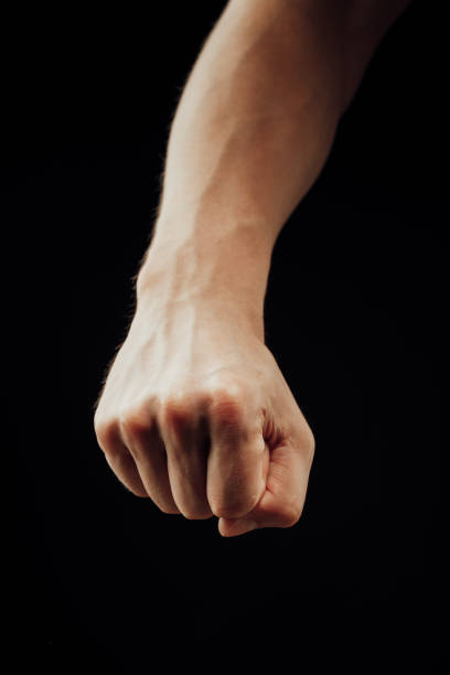 istock male fist, isolated on black 1072179144