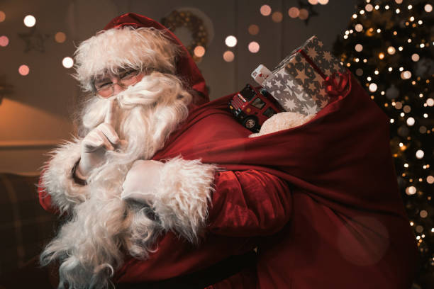 Santa Claus with finger on the lips Santa Claus with finger on the lips gesturing shh sign sack photos stock pictures, royalty-free photos & images