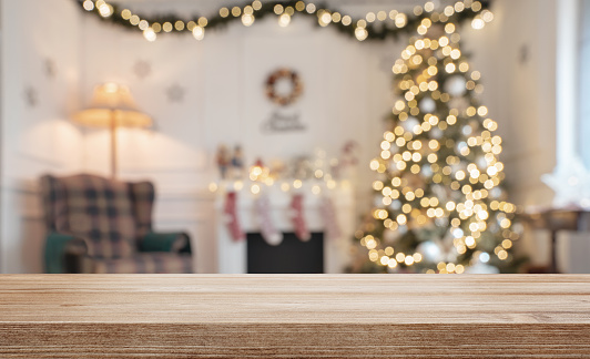 Empty wooden table over defocused christmas background