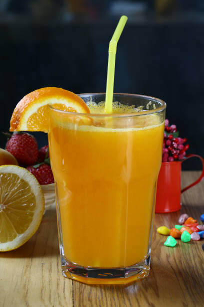 istock Fresh orange juice in glass cup and a sliced orange 1072188800