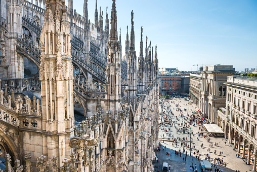 View from roof of Duomo gothic cathedral to piazza square in Milan
