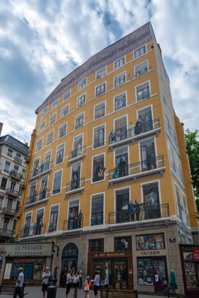 Lyon, France - July 19, 2018: Wall of the Canuts (1987) in the Croix-Rousse district. The huge wall is a realistic painting of a Lyon scene.