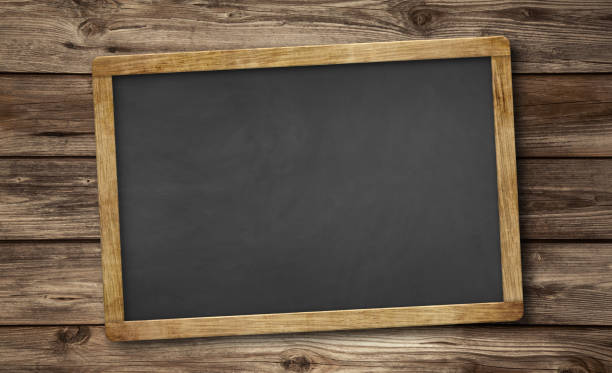 blank slate blackboard and wooden background stock photo