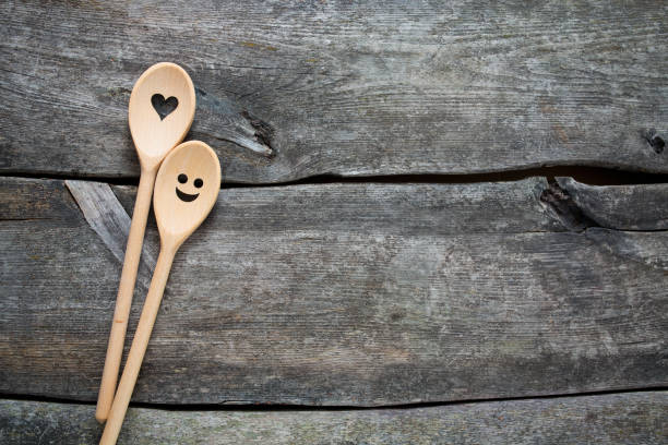 smiling wooden spoons on kitchen table
