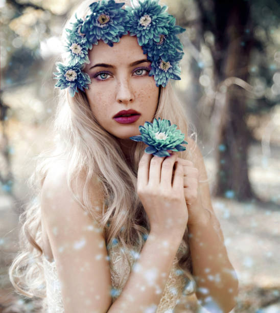 istock Young woman with flowers 1072194694