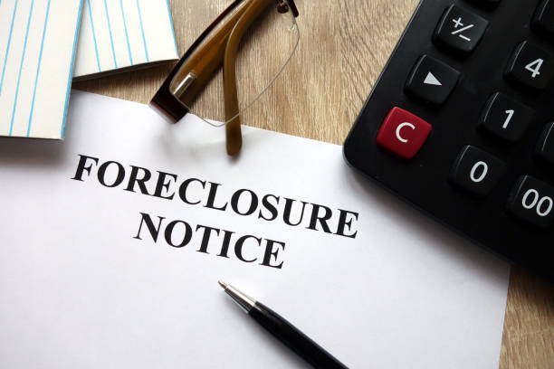 istock Foreclosure notice with pen, calculator and glasses 1072194936