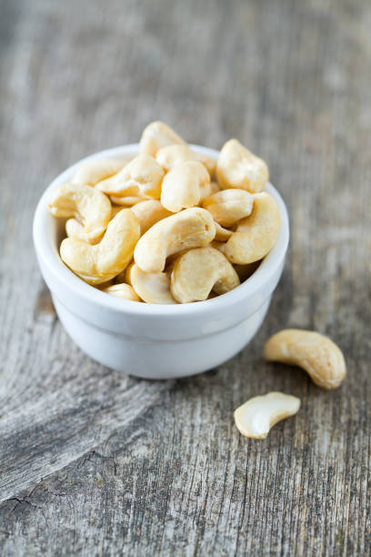 istock cashew nuts on wooden surface 1072194988