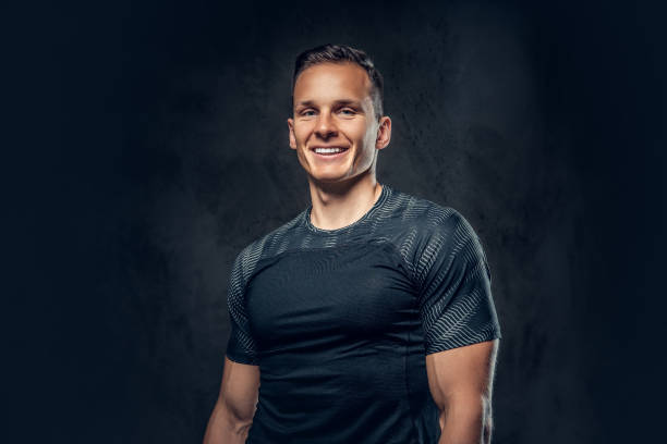 Smiling athletic man on black background stock photo