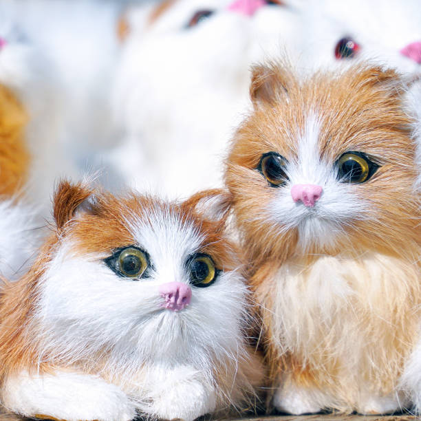 istock Soft toys kittens sitting in front of camera 1072201658