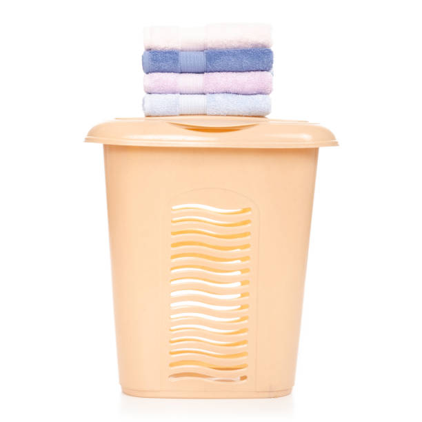 istock Plastic laundry basket with towel female hand 1072203570