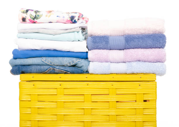 istock Yellow laundry basket with towel and clothing 1072203636