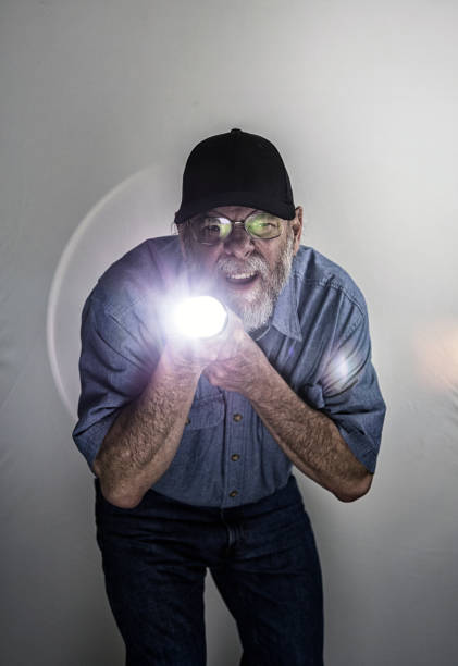 istock Blue Collar Worker Maintenance Repairman Pointing Bright Flashlight 1072203710
