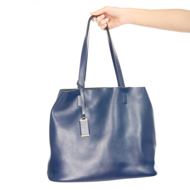 istock Woman's female blue leather bag in hand pulls out of the bag 1072203830