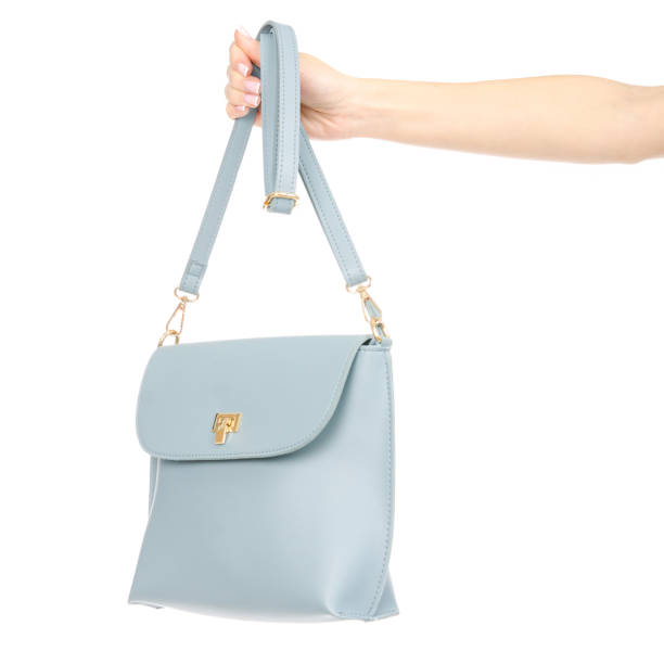 istock Woman's female blue leather bag in hand pulls out of the bag 1072203840