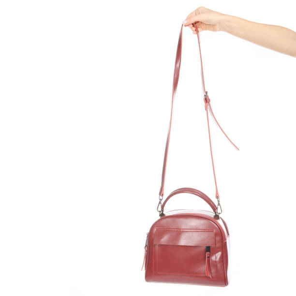 istock Woman's female red leather bag in hand 1072203864