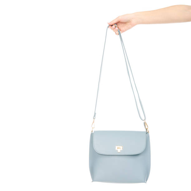 istock Woman's female blue leather bag in hand pulls out of the bag 1072203880
