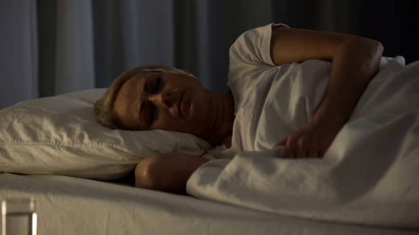 istock Bad looking senior woman sleeping, seeing nightmares and feeling pain in dream 1072204306