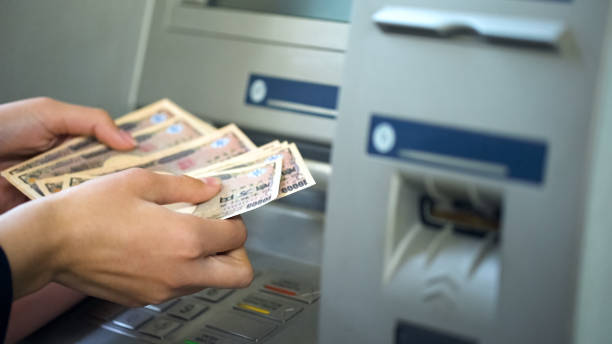 женщина подсчета японских иен сняты из банкомата, 24 часов службы, легкий банковский - women dependency business time стоковые фото и изображения