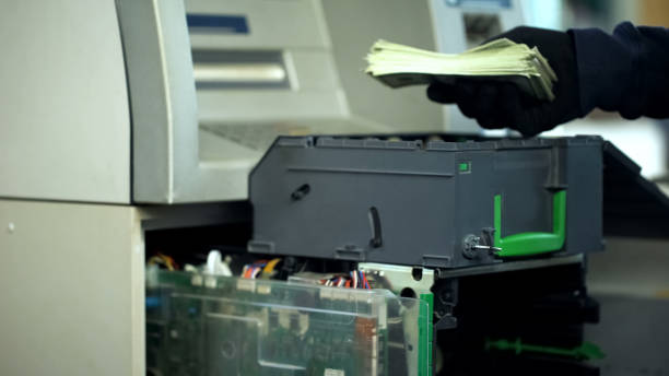 istock Security man opening ATM safe, taking out bundle of dollars, cash-in-transit 1072205390