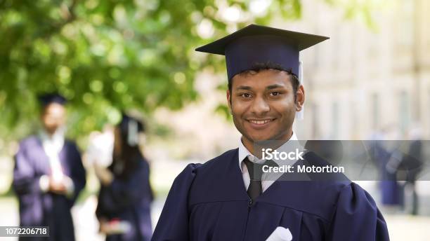 Smiling Hispanic Graduate Student Rejoicing Diploma Success Posing For Camera Stock Photo - Download Image Now