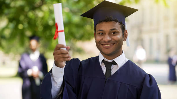 istock Charming Hispanic graduate smiling and showing diploma for camera, success 1072206786