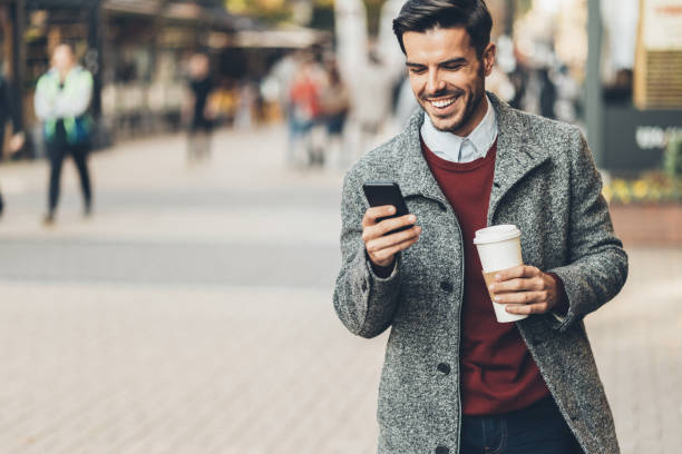 istock Businessman walking and using a smart phone 1072206938