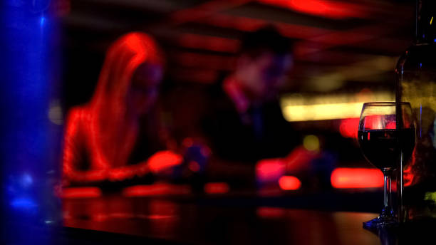 istock Couple using smartphone instead having fun in bar, internet addiction, defocused 1072207312