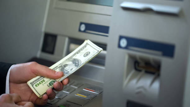 istock Male getting dollars from automatic teller machine, cash withdrawing, banking 1072207672