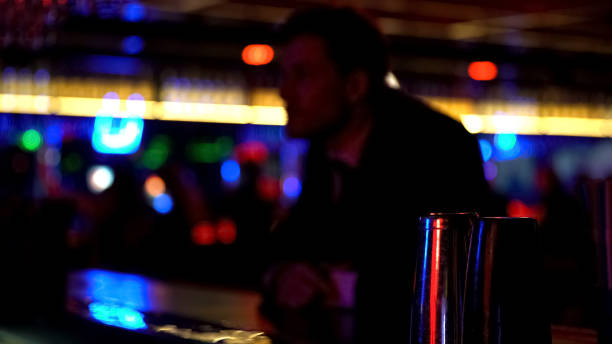 istock Man in suit ordering drinks at bar counter, celebrating alone relaxed atmosphere 1072208300
