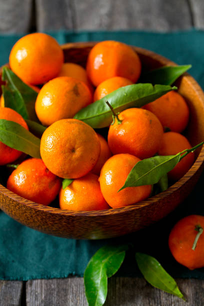 istock mandarines in a wooden bowl 1072208366