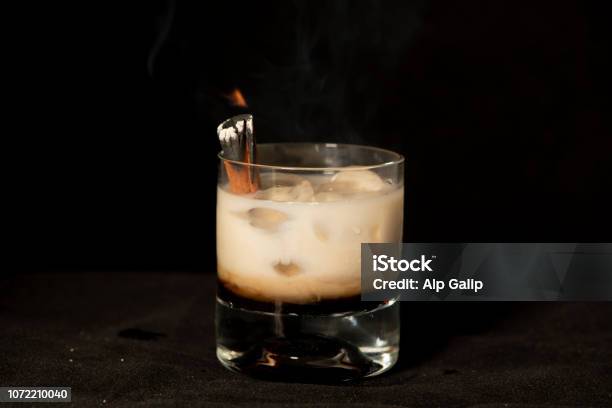 Flaming Cinnamon Cocktail With Kahlua Baileys Irish Cream And Sambuca Stock Photo - Download Image Now