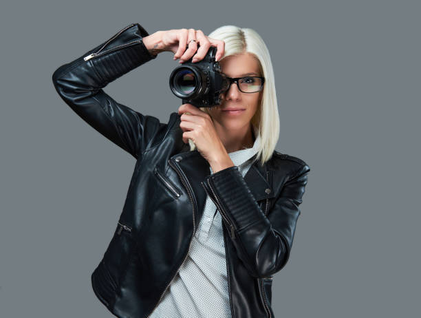 istock A blond female taking pictures with professional digital camera. 1072223286