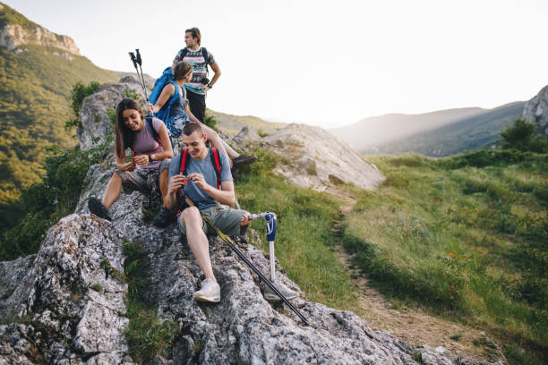 istock Amputee with friends taking a break during nature hiking 1072223304