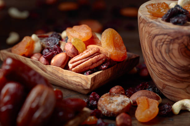istock Various dried fruits and nuts in wooden dish. 1072227714