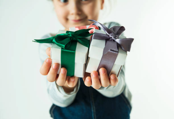istock Little Girl Showing Gift Box 1072227878