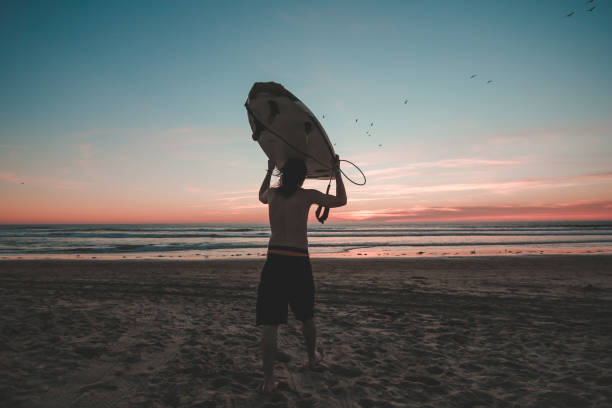 istock Surfer walking against ocean. 1072233758