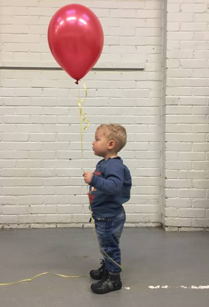 istock Boy and red balloon 1072233966