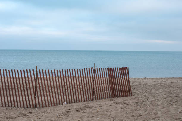 istock Wooden fence as leading line on beach 1072235008