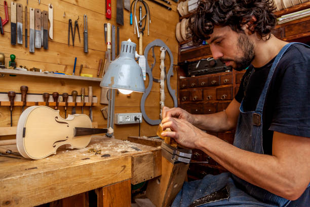 craftsman violinmaker began working stock photo