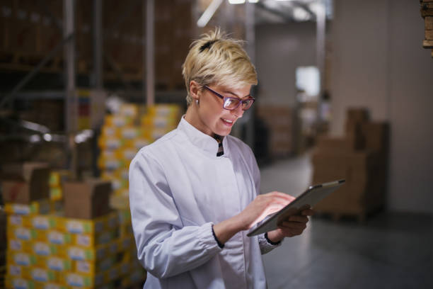 istock Happy Caucasian female worker using tablet in warehouse. In background boxes. 1072246816